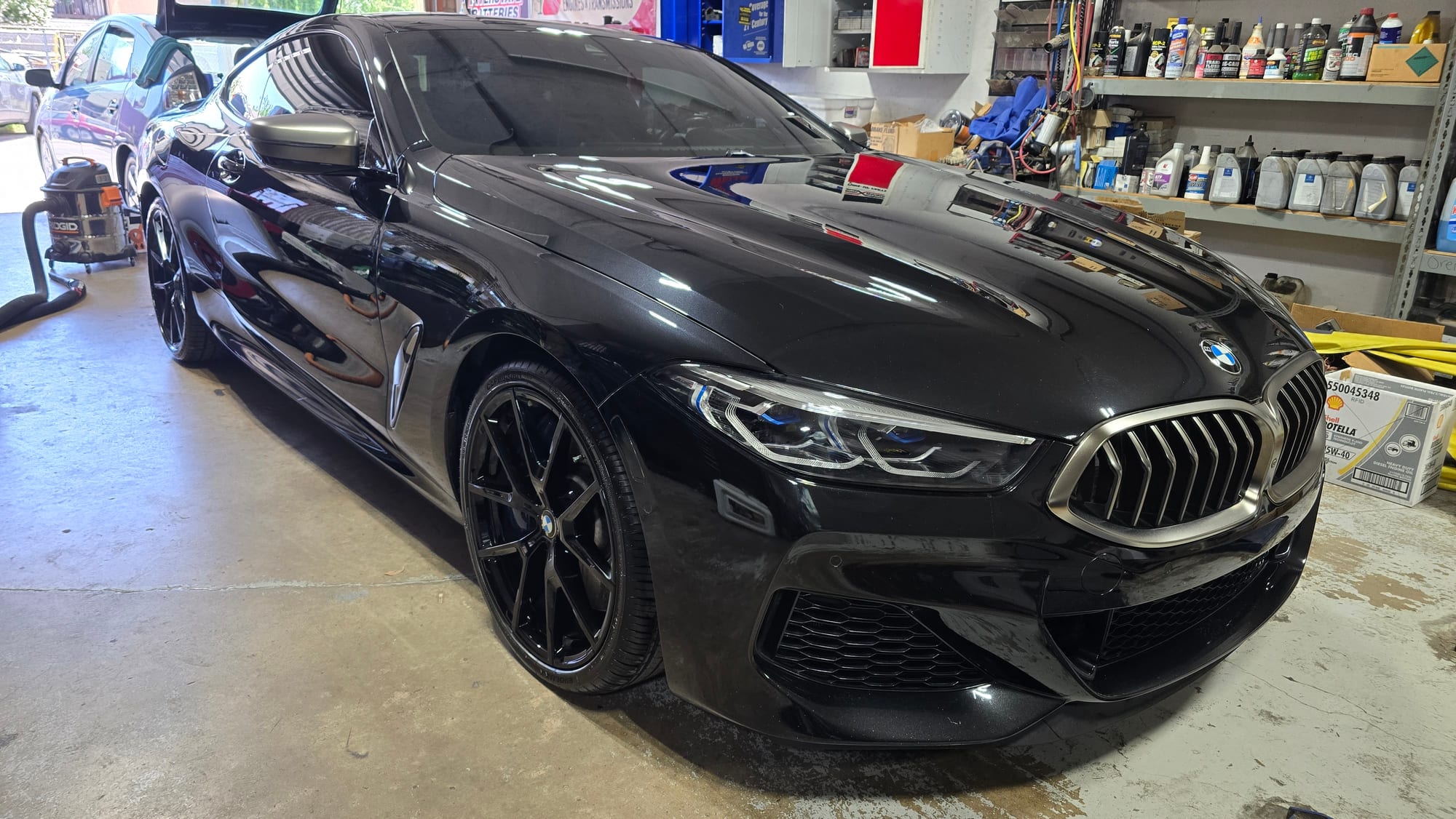 Glossy black BMW M850i coupe after a careful wash and wax