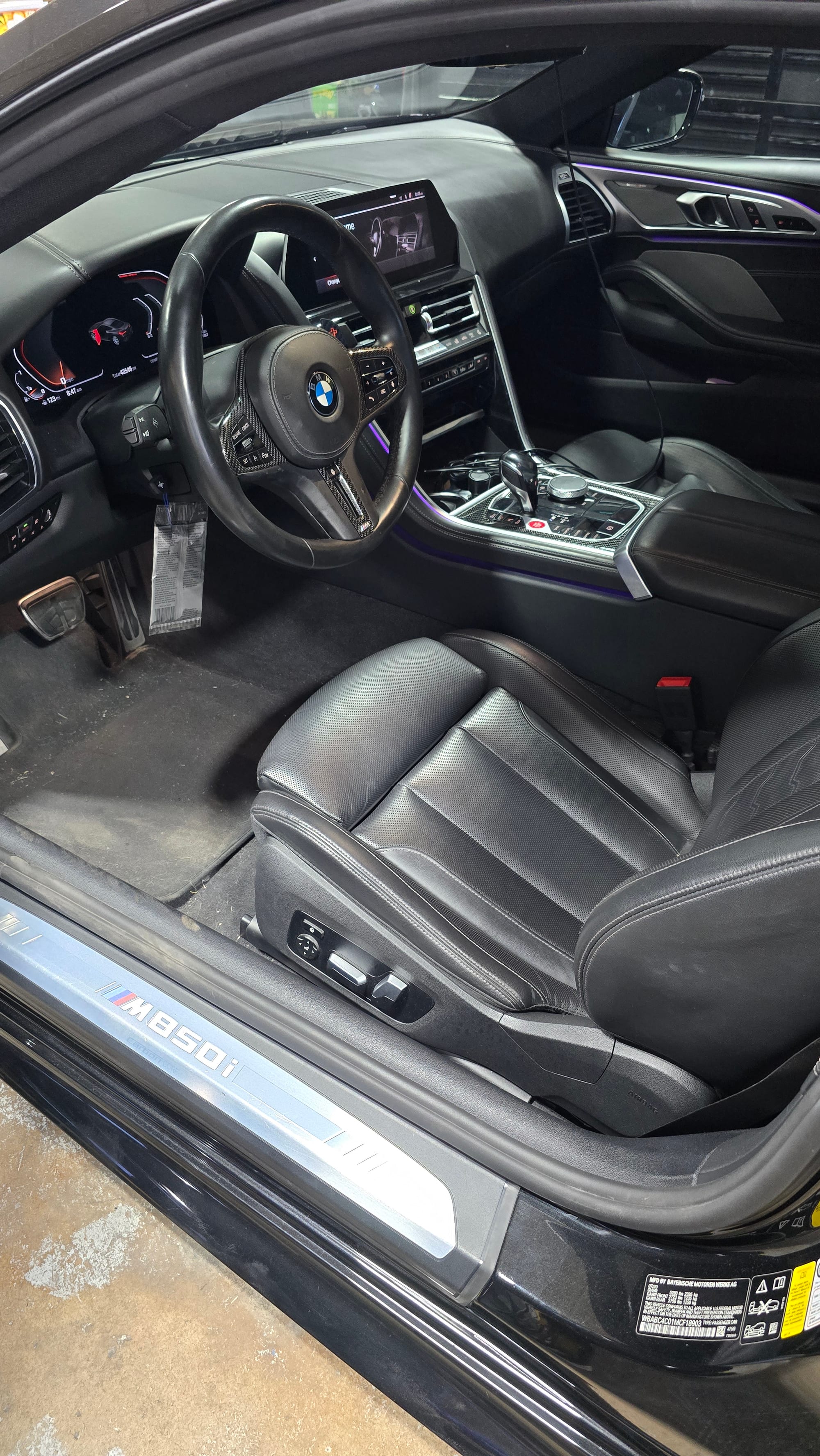 Clean black leather driver seat in a BMW M850i