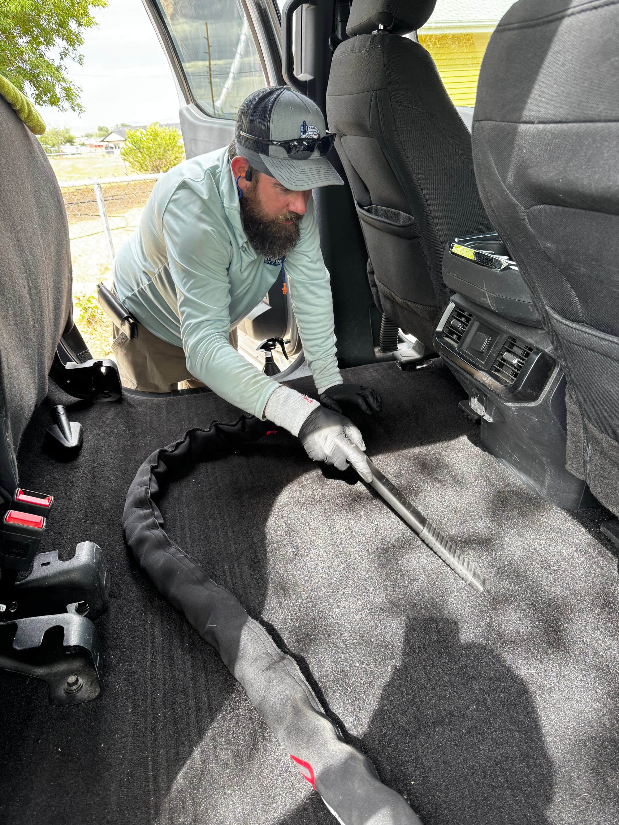 Vacuuming the rear-cab carpet of a Ford F-150