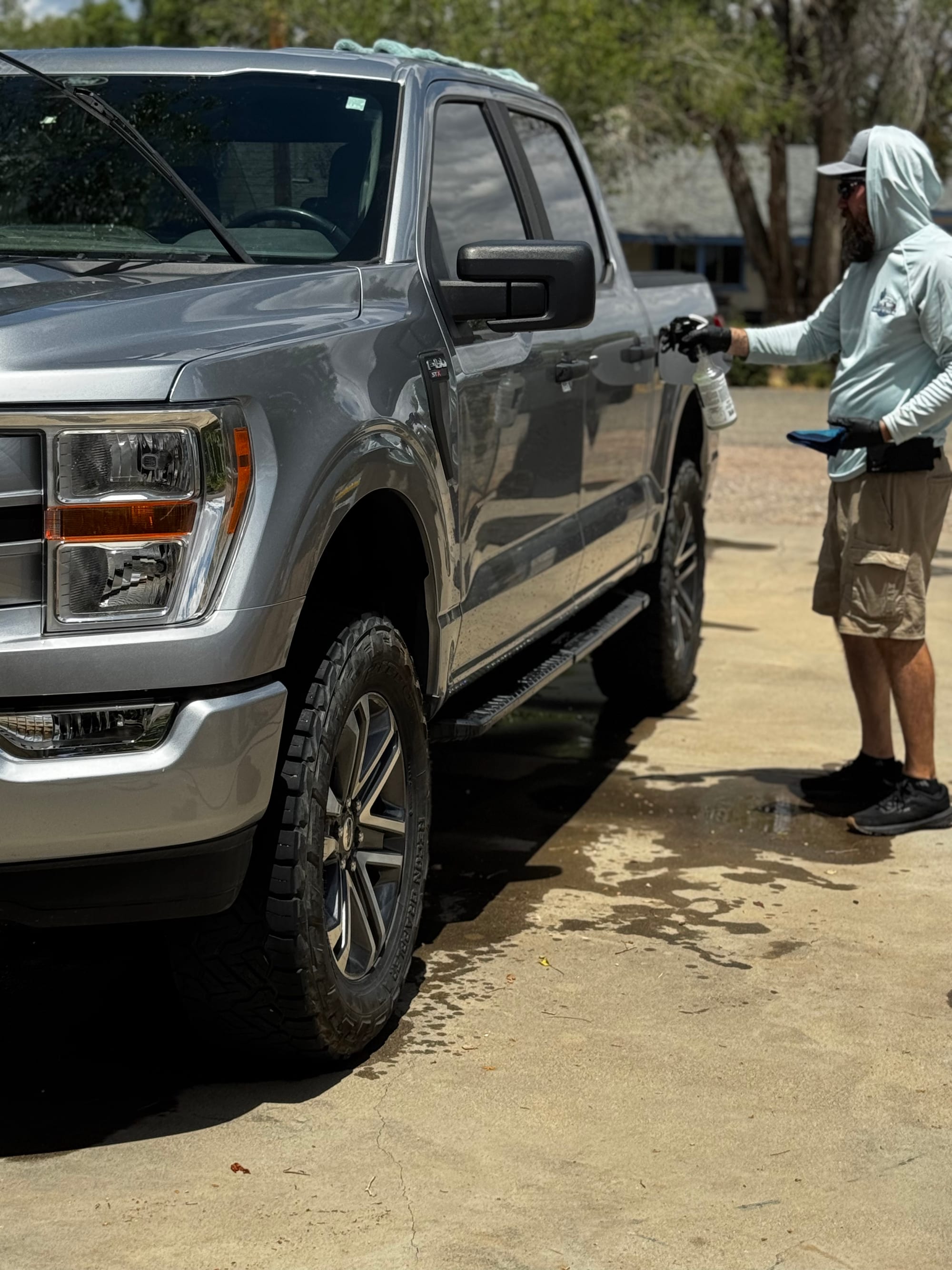 Detail brush cleaning the dashboard vents of a Ford F-150