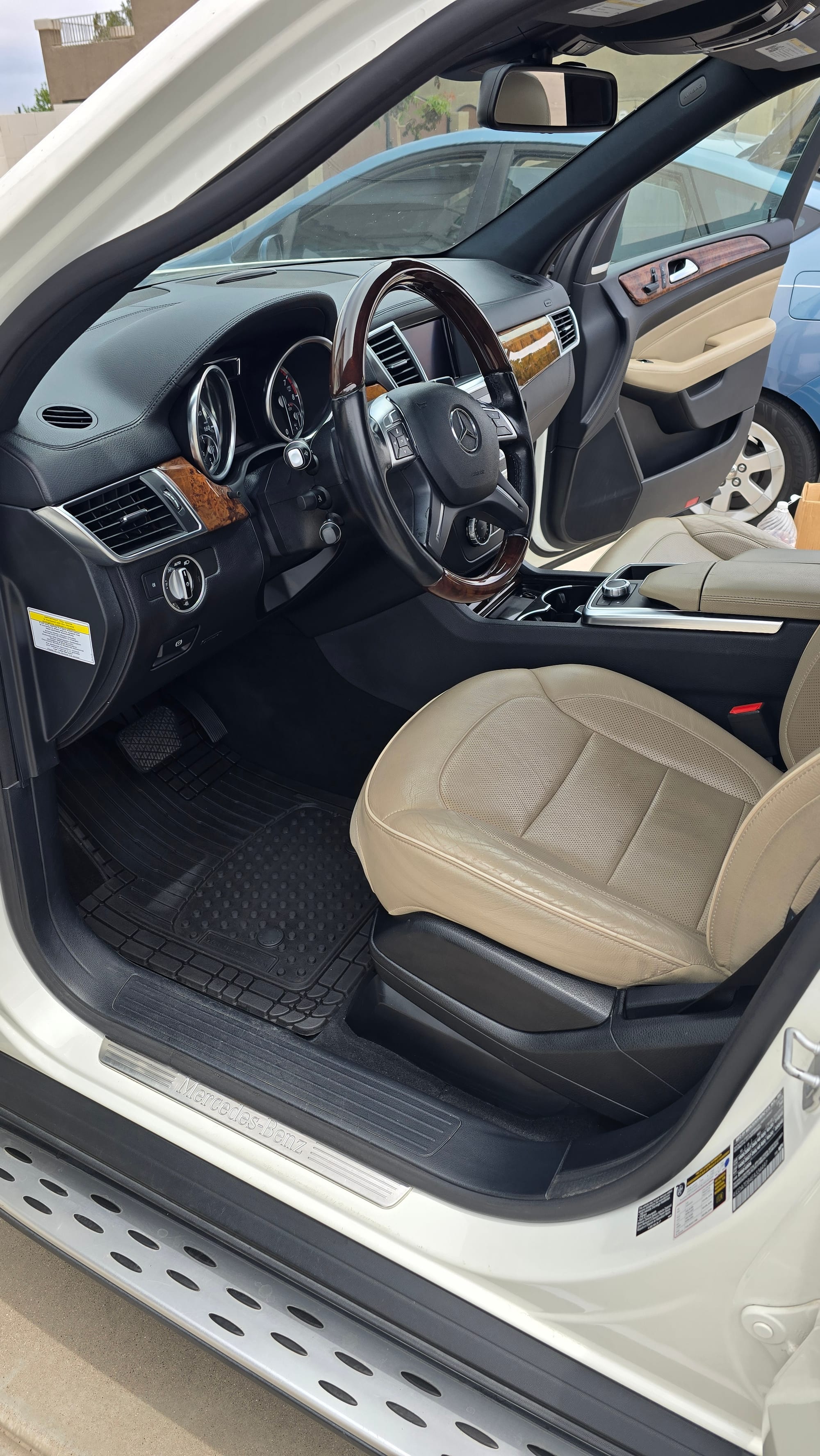 Clean beige leather front seats in a Mercedes-Benz SUV after detailing