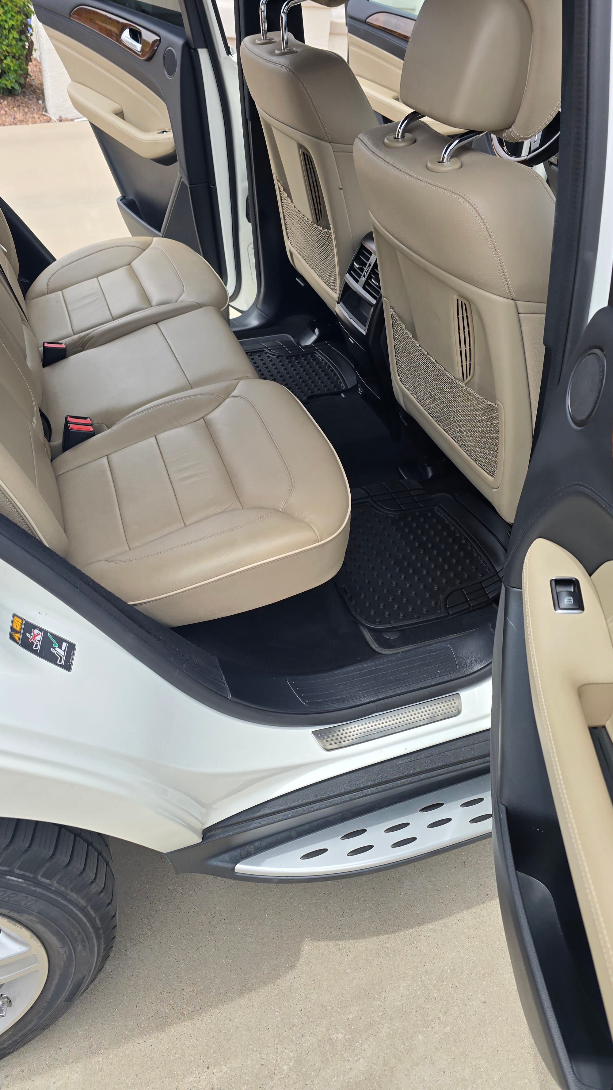 Clean beige leather rear seats in a Mercedes-Benz SUV after detailing