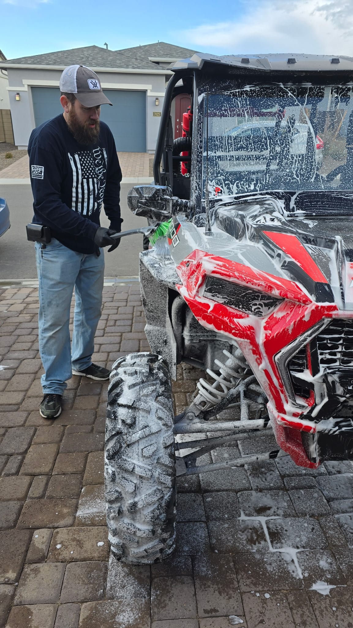 Nathan from Delightful Desert Detailing pressure-washing a Polaris RZR in Glendale